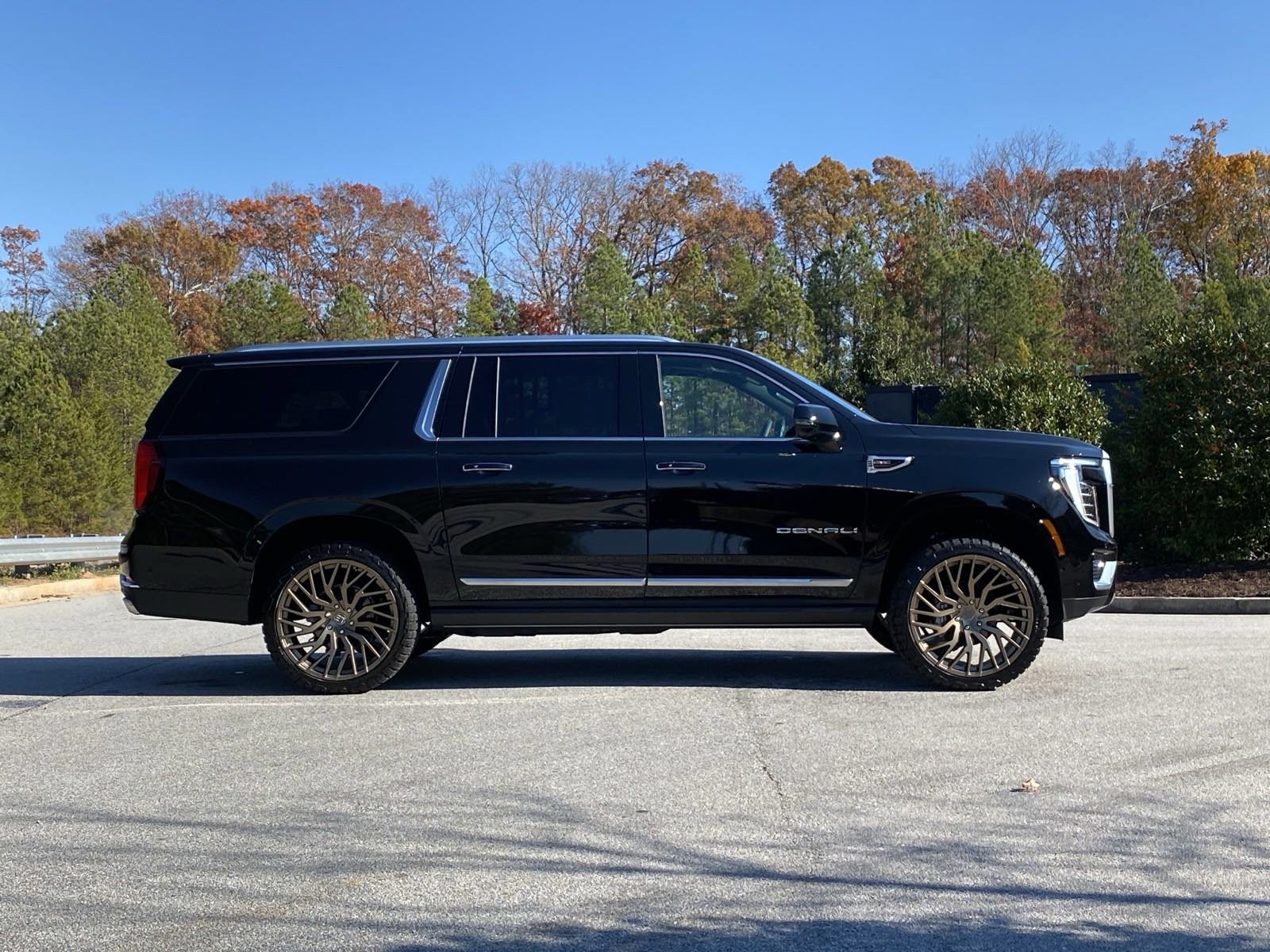 Black GMC Yukon XL Denali side profile with bronze wheels